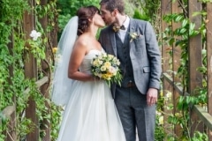 Bride and groom kiss in the garden at Fernhill House Hotel