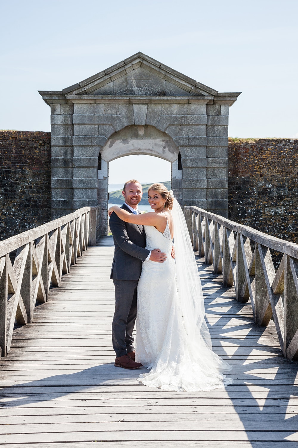 Bride and groom in front of arch of Charles Fort Kinsale
