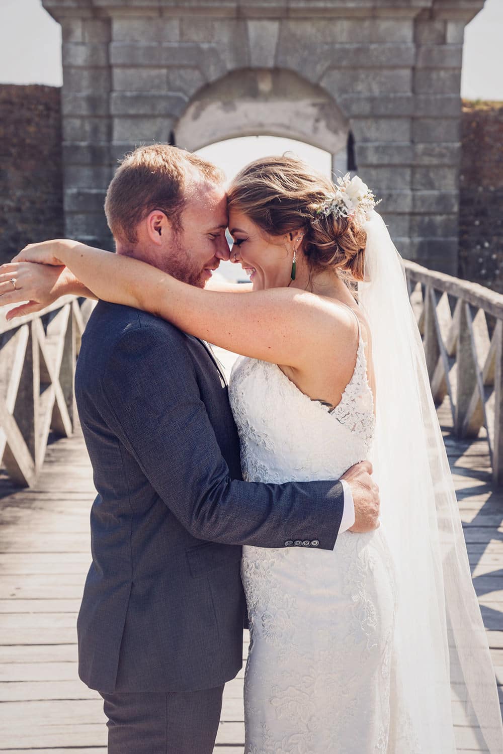 Bride and groom kiss on bridge to Charles Fort Kinsale