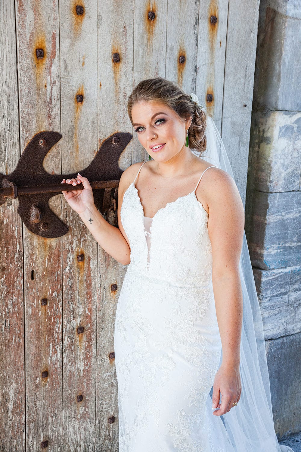 Bride poses in front of door at Charles Fort Kinsale