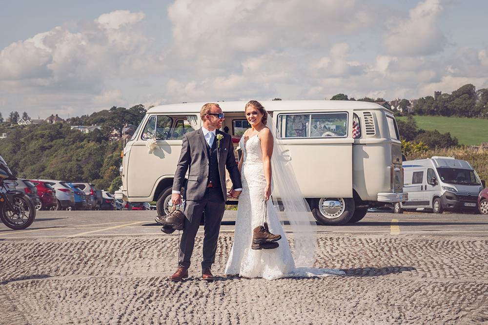 Bride and Groom pose in front of VW camper can Kinsale