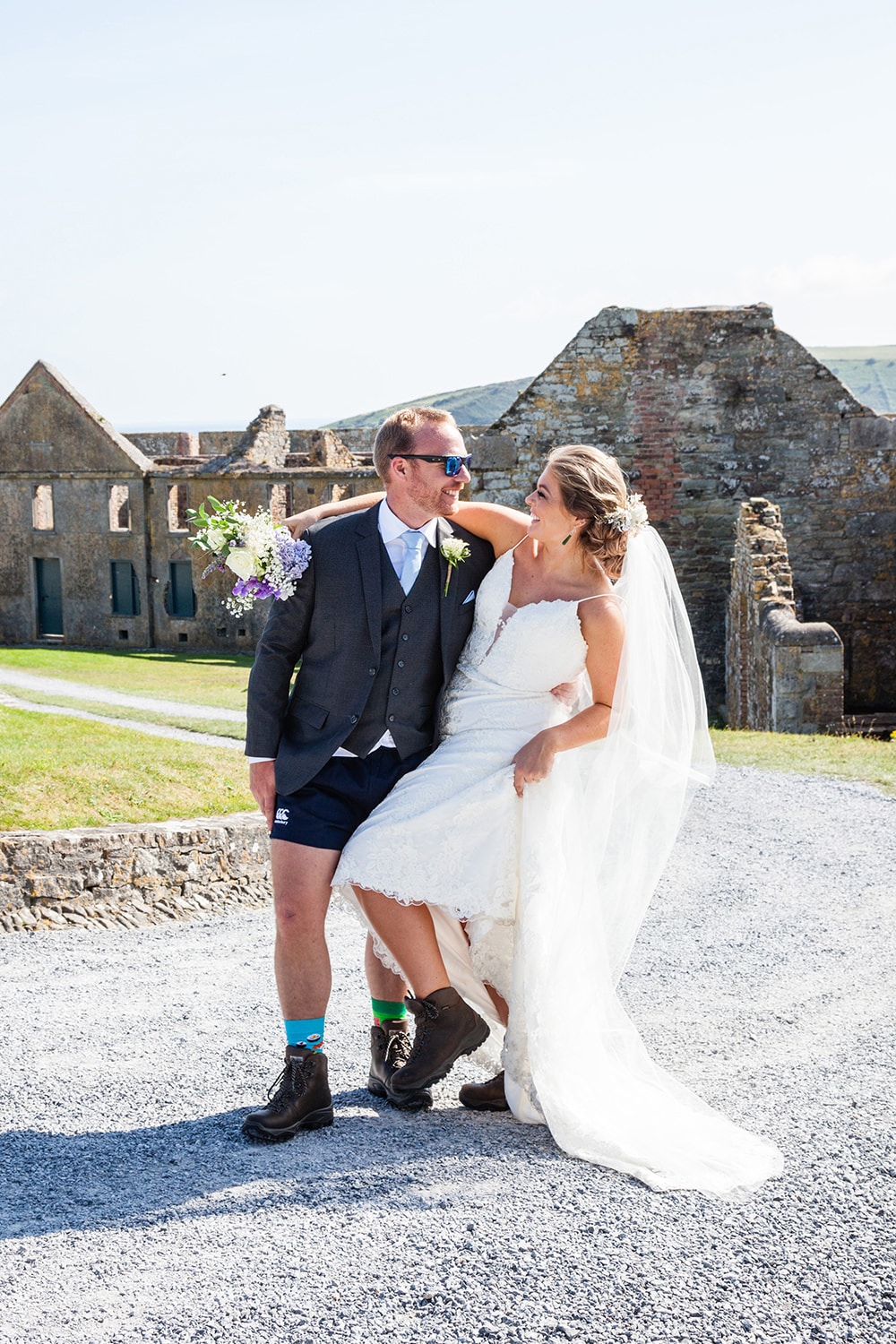 Bride and groom in hiking boots in front of Charles Fort Kinsale