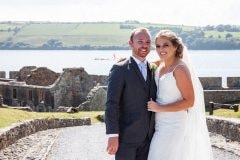 Bride and Groom pose before ruins of Charles Fort Kinsale