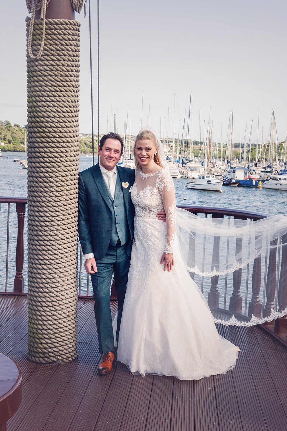 Bride and Groom pose in front of Kinsale harbour