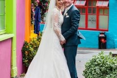 bride and groom posing in colourful Kinsale